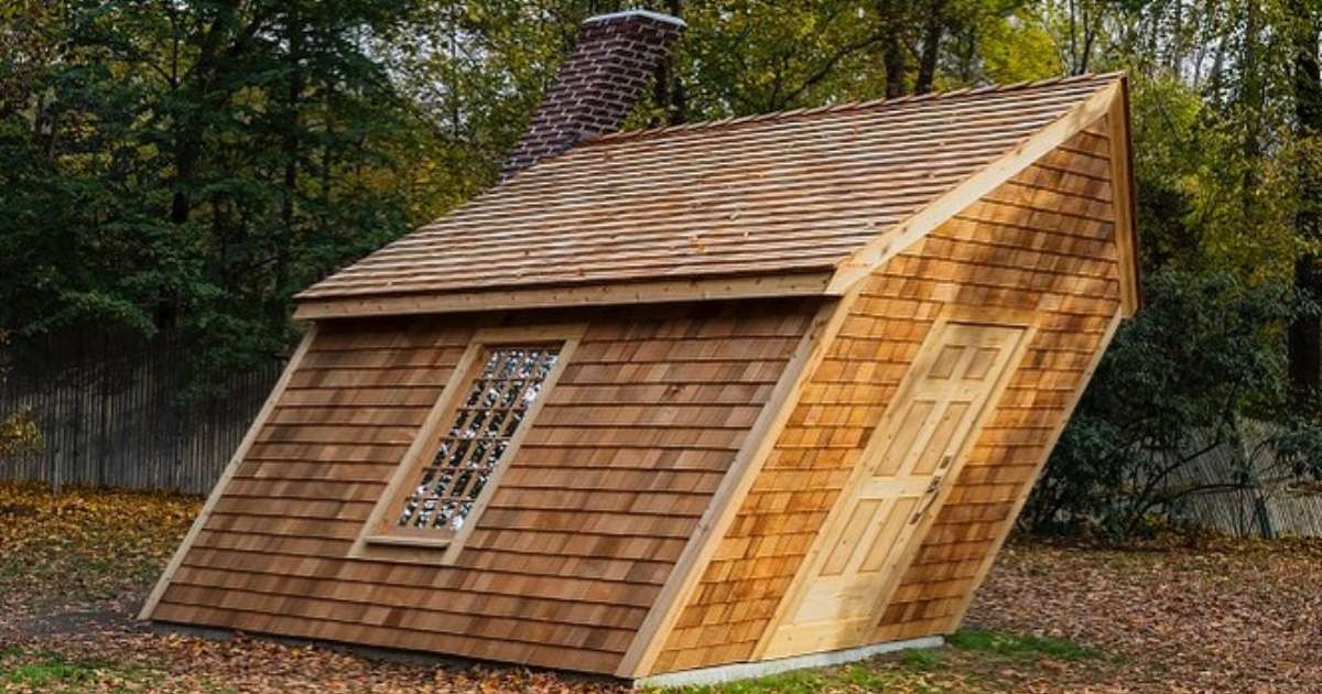 A sculpture of a slanted home at deCordova Sculpture Park and Museum