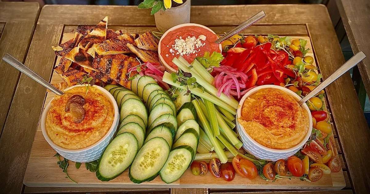A platter of vegetables, hummus, and pita chips at The Tack Room