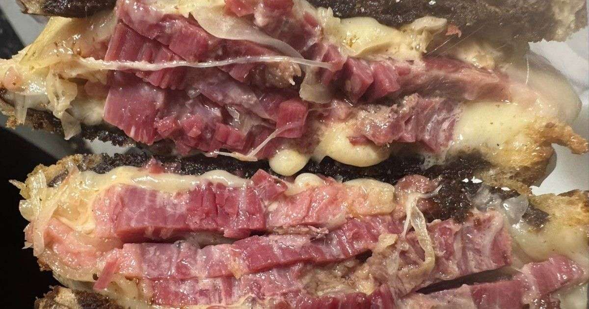 A Reuben sandwich on a white plate from Franny's Diner