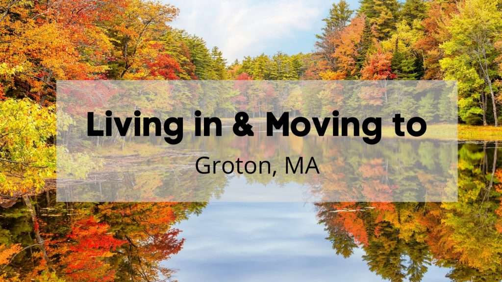 A lake in Groton MA surrounded by trees during fall in New England. The leaves on the trees are fall colors: browns, oranges, yellows.