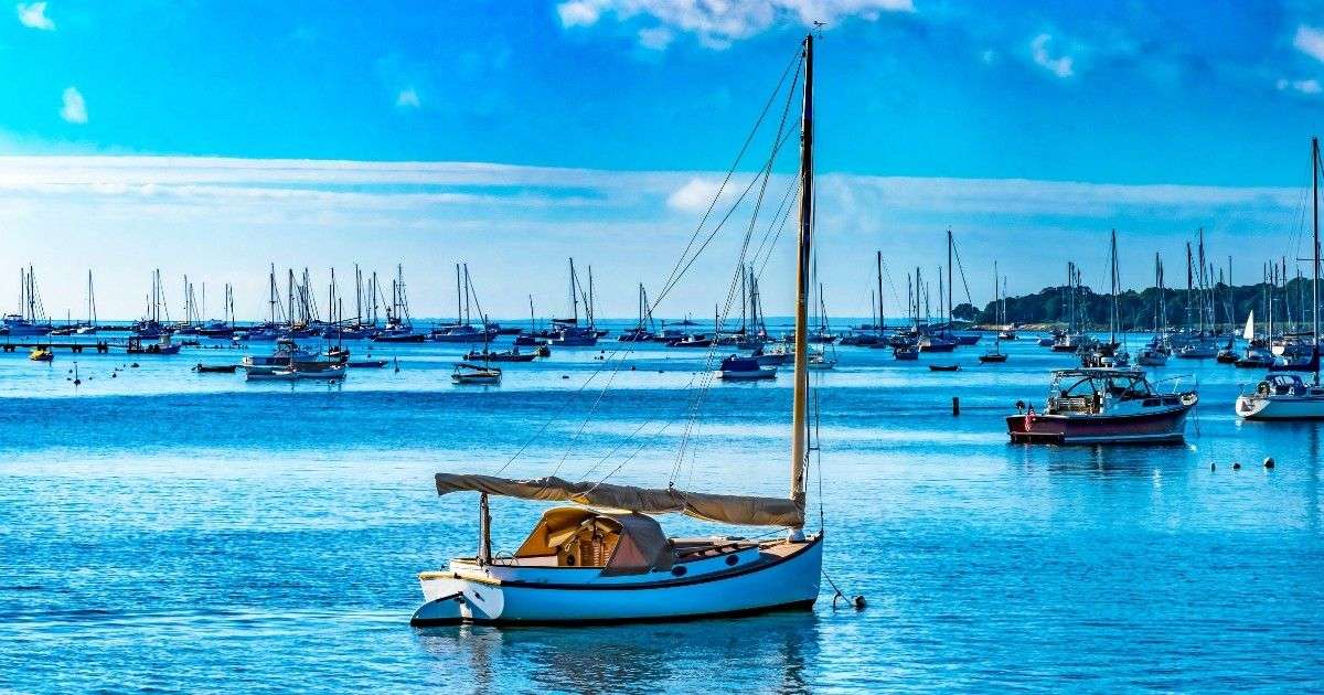 Scenic view of boats and coastal homes near Padanaram Harbor in Dartmouth MA, a popular area for sailing and waterfront living Dartmouth MA. Mass Bay Movers can help you move quickly and efficiently.