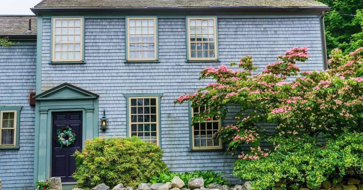 Classic New England home with cedar shingles and blooming gardens in Dartmouth MA, showcasing the town’s historic charm and peaceful neighborhoods for anyone moving to Dartmouth with Mass Bay Movers.